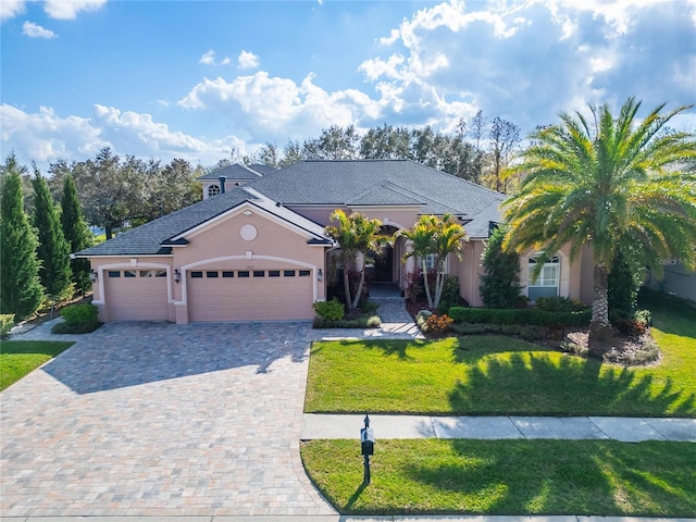 view of front facade with a garage and a front lawn