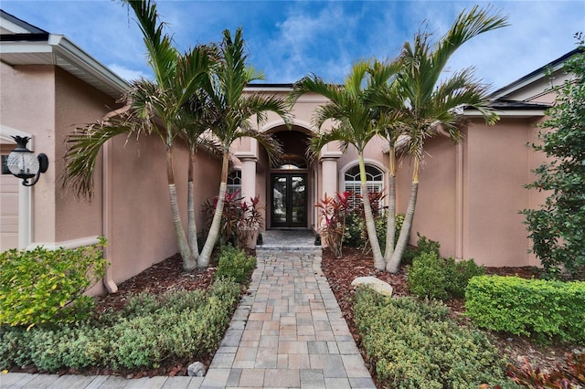 entrance to property featuring stucco siding