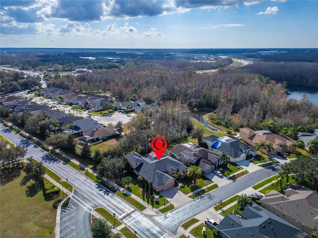 birds eye view of property with a residential view and a water view