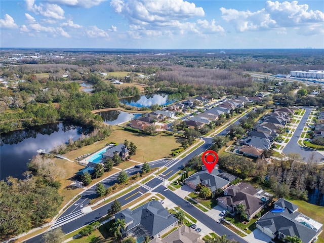 drone / aerial view with a water view and a residential view