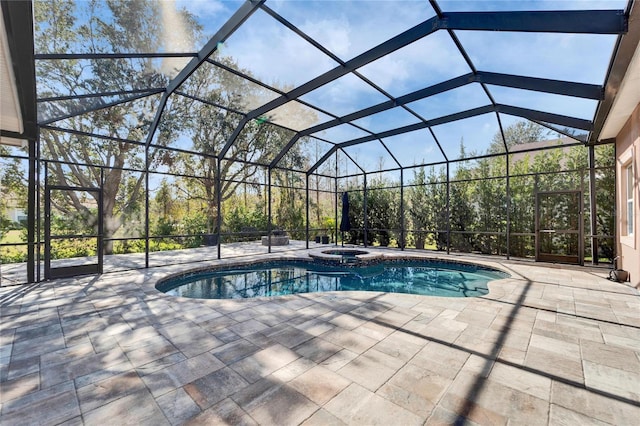 view of pool with a patio area, a lanai, and a pool with connected hot tub