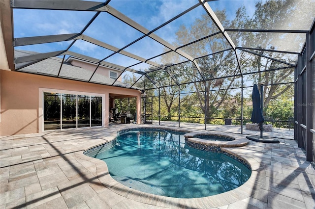 view of pool with a lanai, a pool with connected hot tub, and a patio