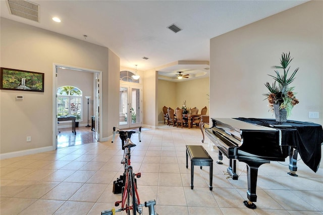 foyer entrance featuring light tile patterned floors, french doors, and ceiling fan