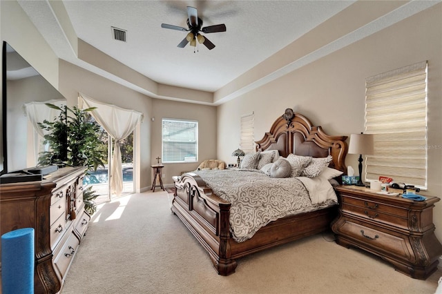 carpeted bedroom featuring access to exterior, visible vents, a ceiling fan, a textured ceiling, and baseboards