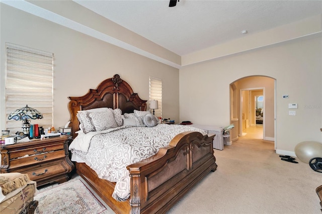 bedroom featuring light colored carpet and ceiling fan