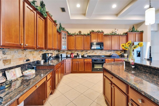 kitchen featuring light tile patterned floors, decorative light fixtures, decorative backsplash, black appliances, and glass insert cabinets