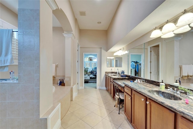 bathroom with connected bathroom, a sink, visible vents, tile patterned floors, and double vanity