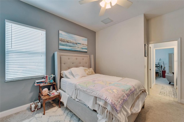 bedroom with baseboards, ceiling fan, visible vents, and light colored carpet