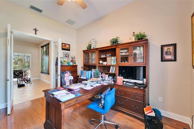 office area featuring light wood-type flooring, ceiling fan, visible vents, and baseboards