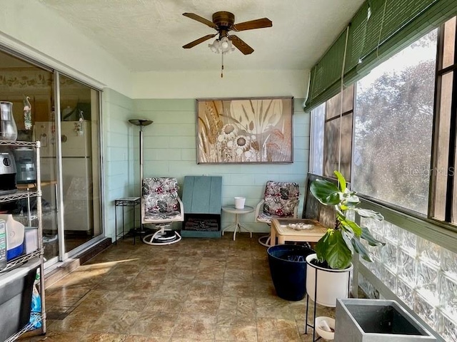 sunroom with a wealth of natural light and ceiling fan