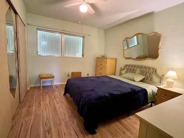 bedroom featuring light wood-type flooring, a closet, and ceiling fan