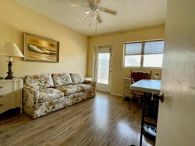 living room featuring hardwood / wood-style floors and ceiling fan