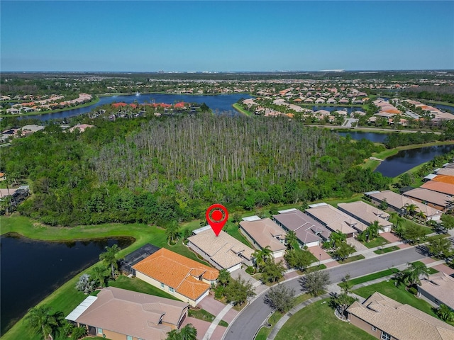 drone / aerial view with a residential view and a water view