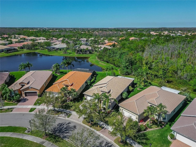 drone / aerial view featuring a residential view and a water view