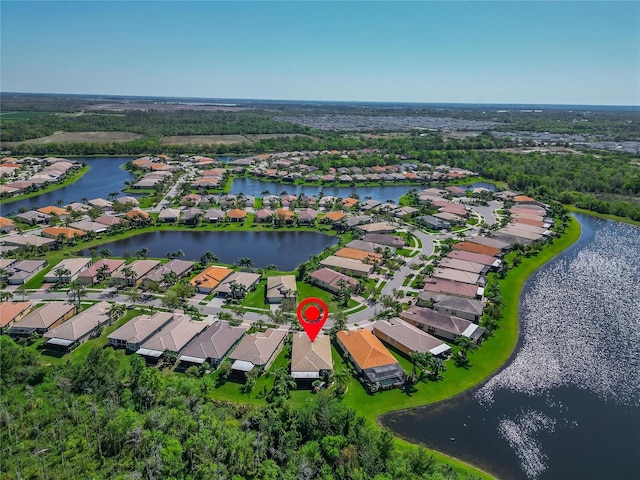 birds eye view of property with a residential view and a water view