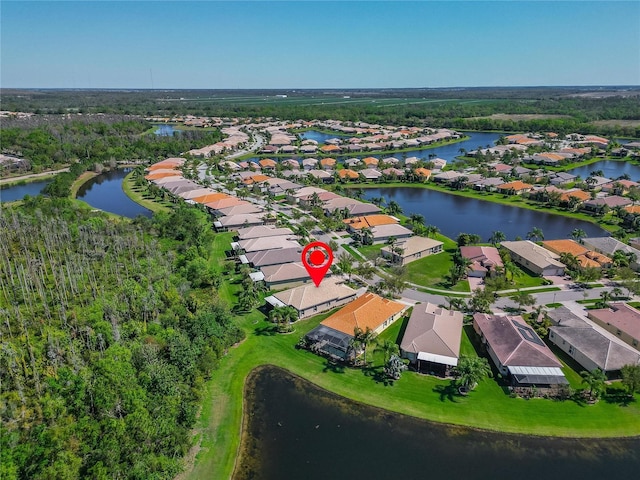 drone / aerial view featuring a residential view and a water view