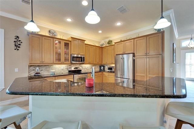 kitchen with visible vents, backsplash, appliances with stainless steel finishes, and crown molding