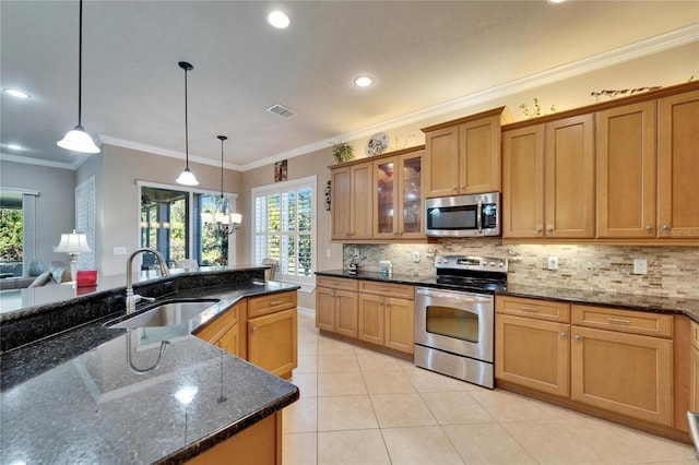 kitchen featuring tasteful backsplash, pendant lighting, light tile patterned flooring, stainless steel appliances, and a sink