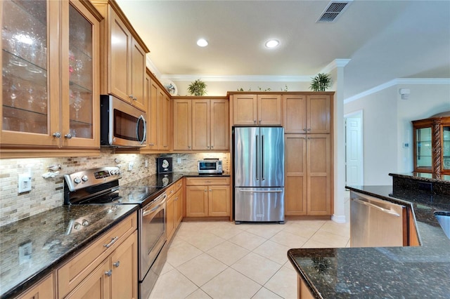 kitchen featuring crown molding, light tile patterned floors, visible vents, and appliances with stainless steel finishes