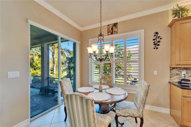 dining area with light tile patterned flooring, a chandelier, crown molding, and baseboards