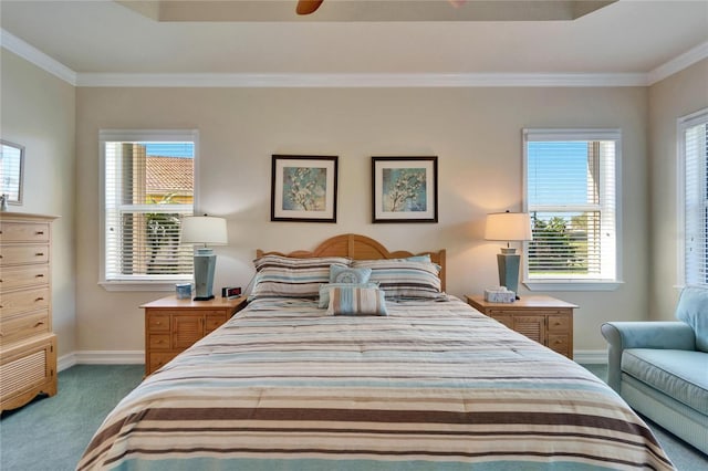 bedroom with a tray ceiling, carpet flooring, crown molding, and baseboards