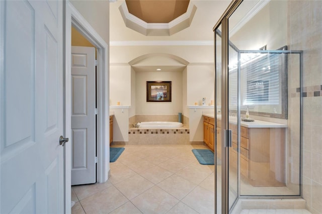 full bathroom featuring tile patterned flooring, crown molding, a stall shower, a bath, and vanity