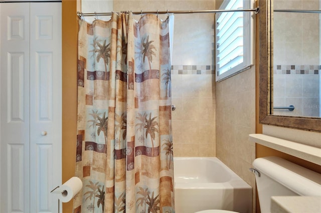 bathroom featuring shower / bath combination with curtain, toilet, and a closet