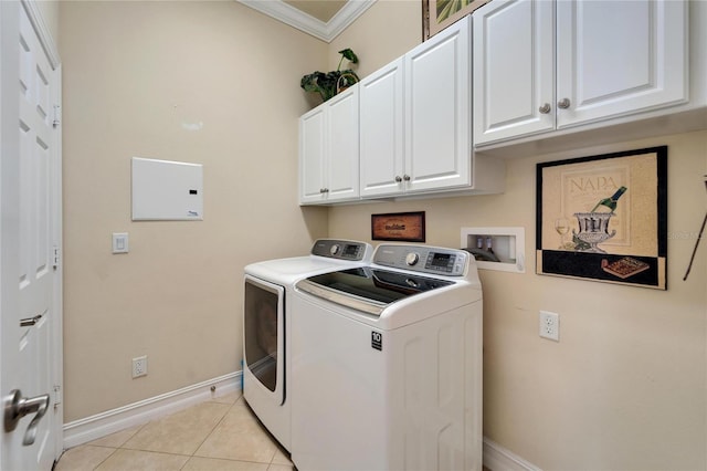 clothes washing area featuring washer and dryer, cabinet space, light tile patterned flooring, crown molding, and baseboards