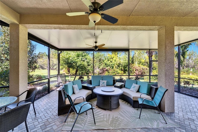 sunroom with a ceiling fan