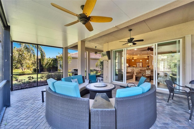 view of patio / terrace with a lanai, a ceiling fan, and an outdoor hangout area