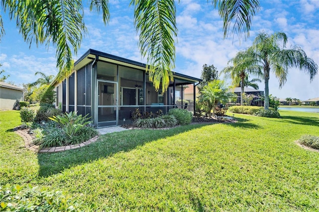 exterior space with a water view and a sunroom