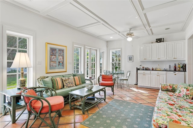 sunroom / solarium featuring ceiling fan, coffered ceiling, and a wealth of natural light