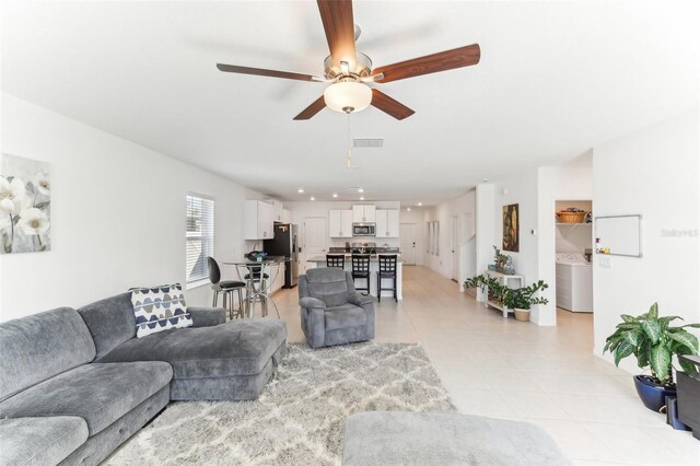 4323 Trotters Way, Lakeland, FL 33801 - tiled living room featuring washer / clothes dryer and ceiling fan