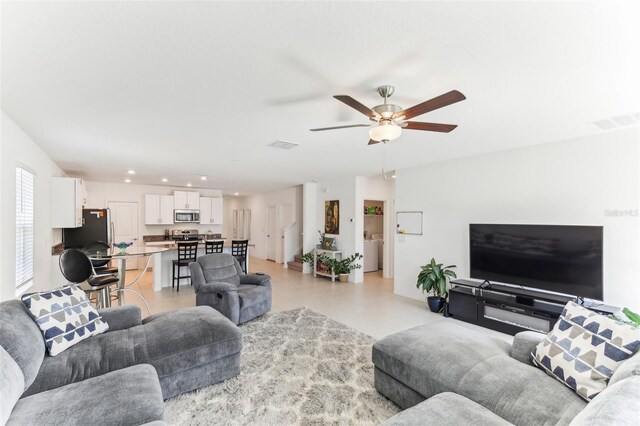 4323 Trotters Way, Lakeland, FL 33801 - living room featuring washer / dryer and ceiling fan