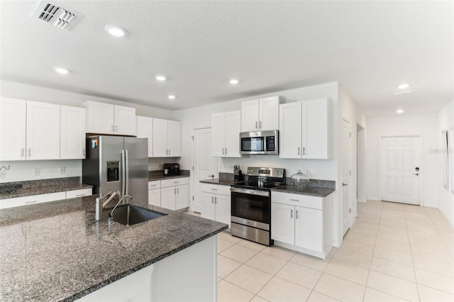4323 Trotters Way, Lakeland, FL 33801 - kitchen with white cabinetry, appliances with stainless steel finishes, sink, and dark stone countertops