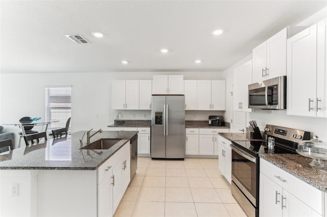 4323 Trotters Way, Lakeland, FL 33801 - kitchen with white cabinetry, stainless steel appliances, a kitchen island with sink, and sink