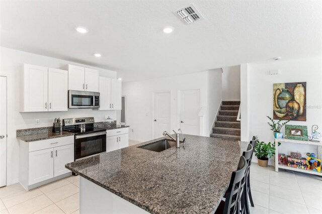 4323 Trotters Way, Lakeland, FL 33801 - kitchen featuring white cabinetry, sink, dark stone countertops, and appliances with stainless steel finishes