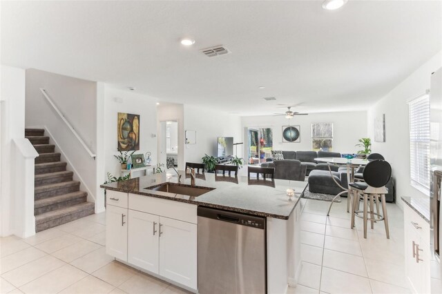 4323 Trotters Way, Lakeland, FL 33801 - kitchen with sink, a center island with sink, stainless steel dishwasher, dark stone counters, and white cabinets
