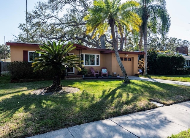 view of front facade featuring a garage and a front lawn