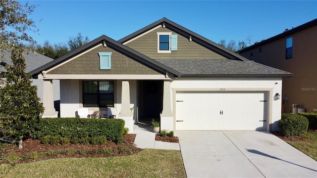 view of front of house featuring a garage and a porch