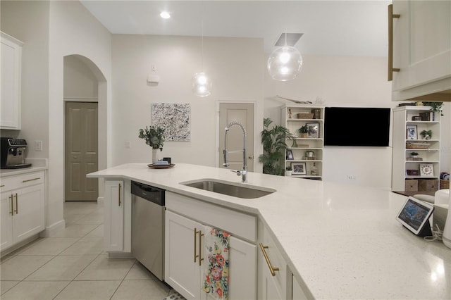 kitchen featuring stainless steel dishwasher, decorative light fixtures, sink, and white cabinets