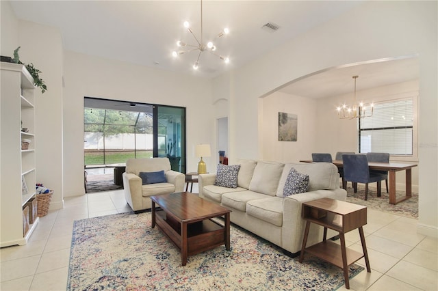 tiled living room featuring an inviting chandelier