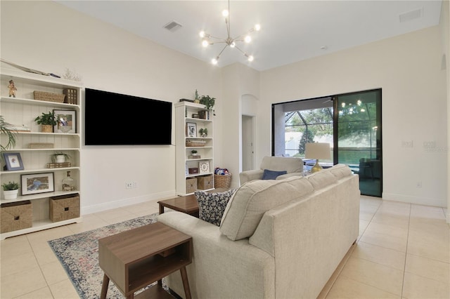 tiled living room featuring an inviting chandelier