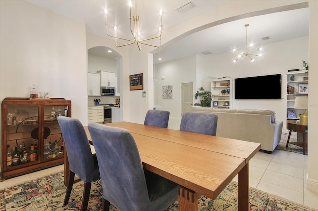 dining space with an inviting chandelier and light tile patterned flooring