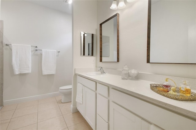 bathroom featuring vanity, tile patterned floors, and toilet