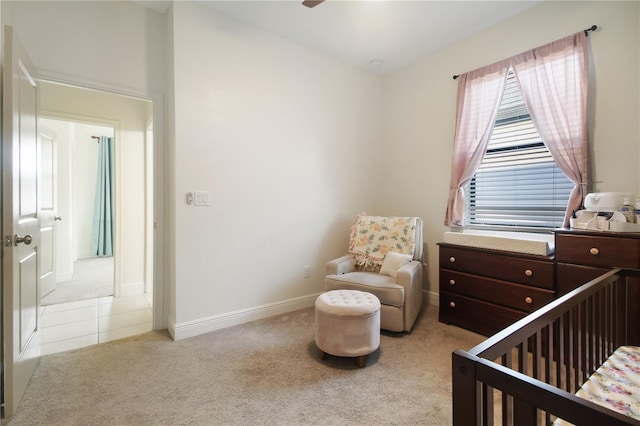 carpeted bedroom featuring a nursery area