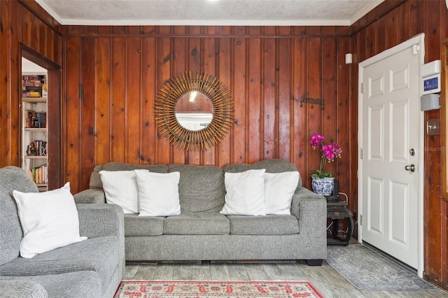 living room featuring wooden walls and light hardwood / wood-style flooring