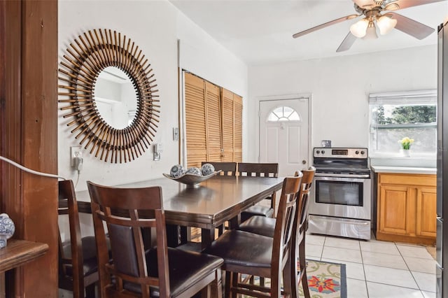 tiled dining area featuring ceiling fan and a wealth of natural light