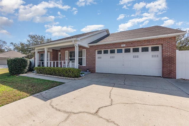 ranch-style home with a garage, covered porch, and a front lawn