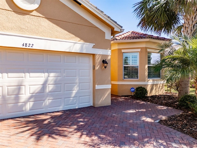 garage with decorative driveway